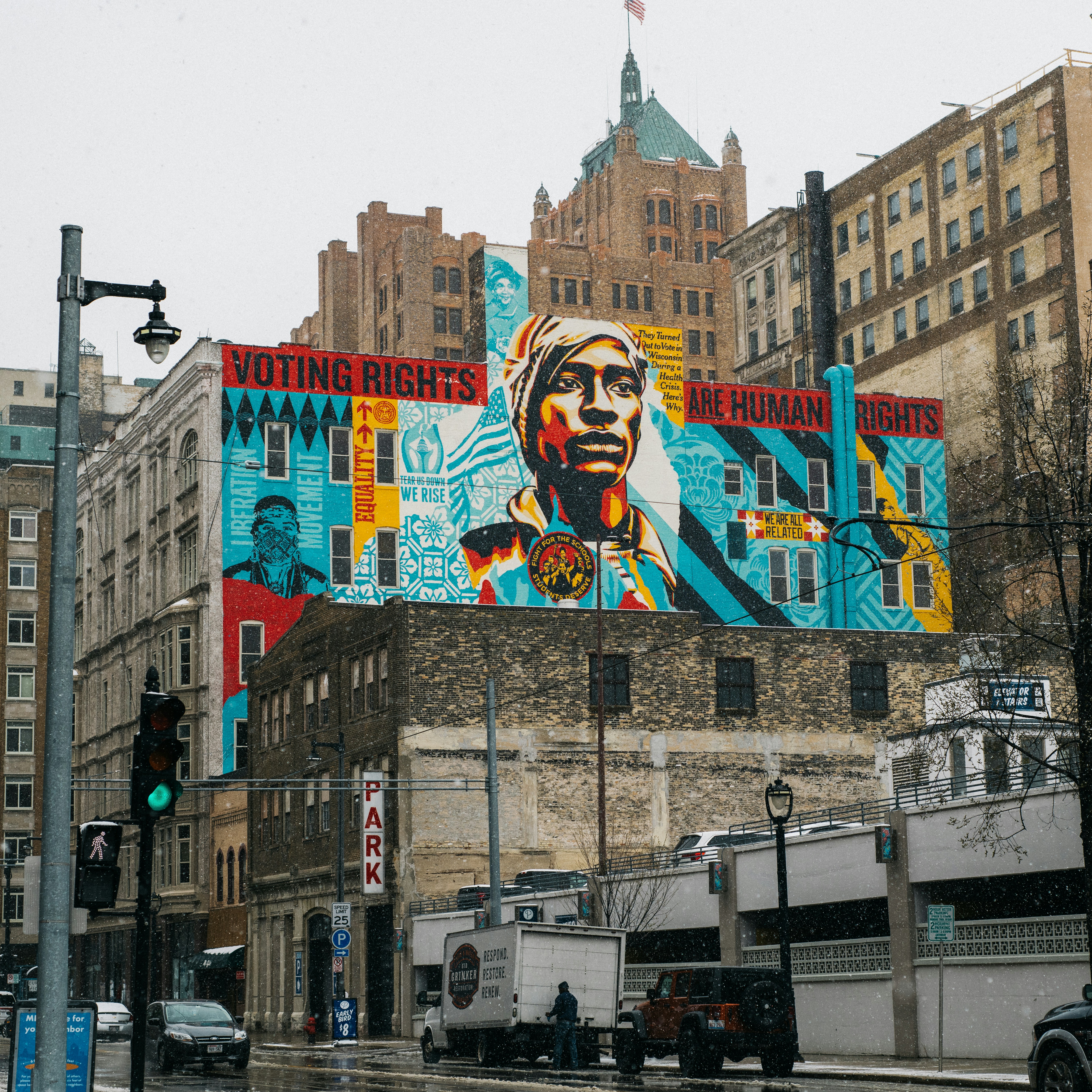 A large downtown mural reading 'Voting Rights Are Human Rights,' painted on the side of a building.